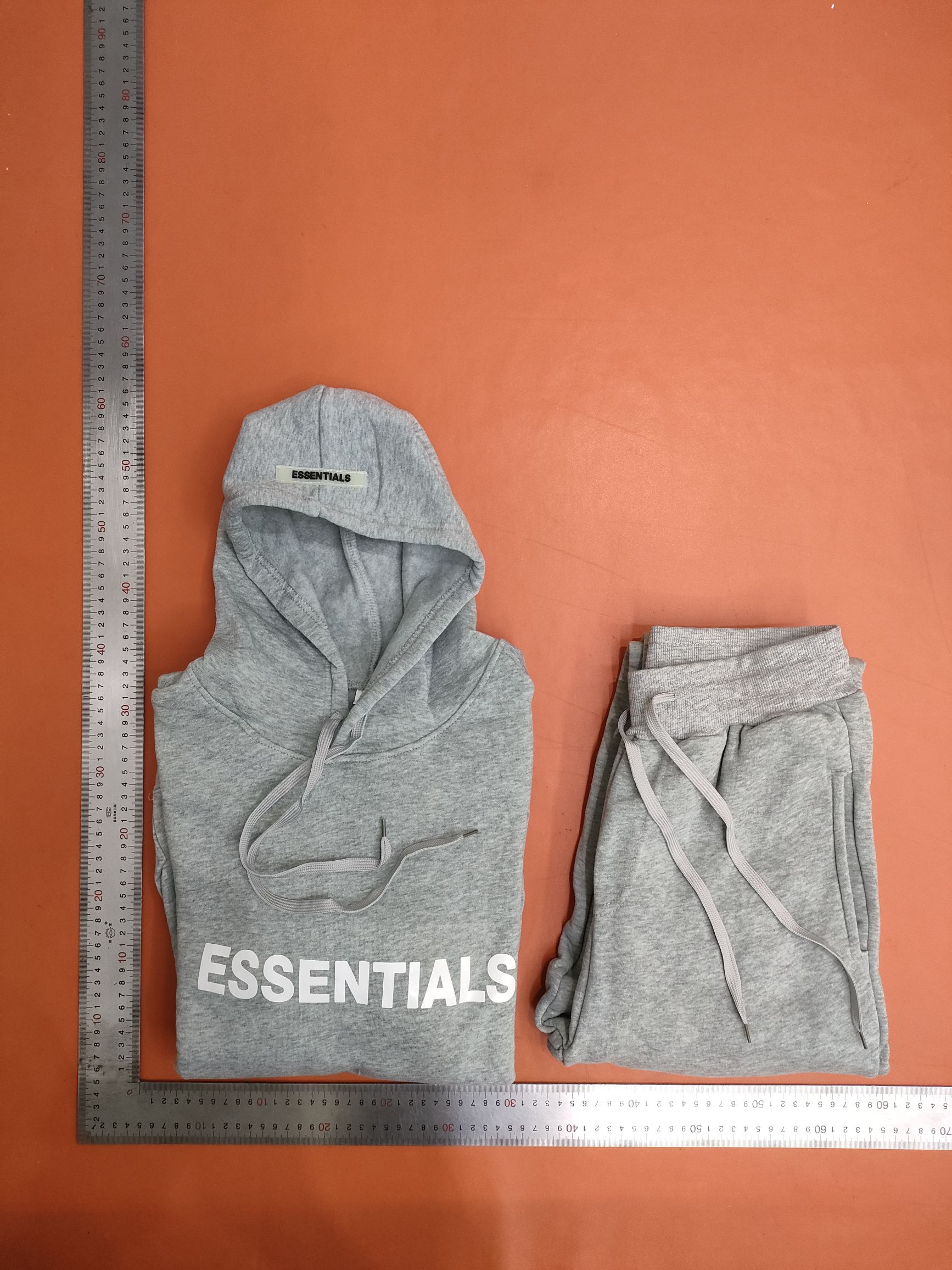 FEAR OF GOD EssenTIALS couples with two sets of tiaras for men and women in protective clothing